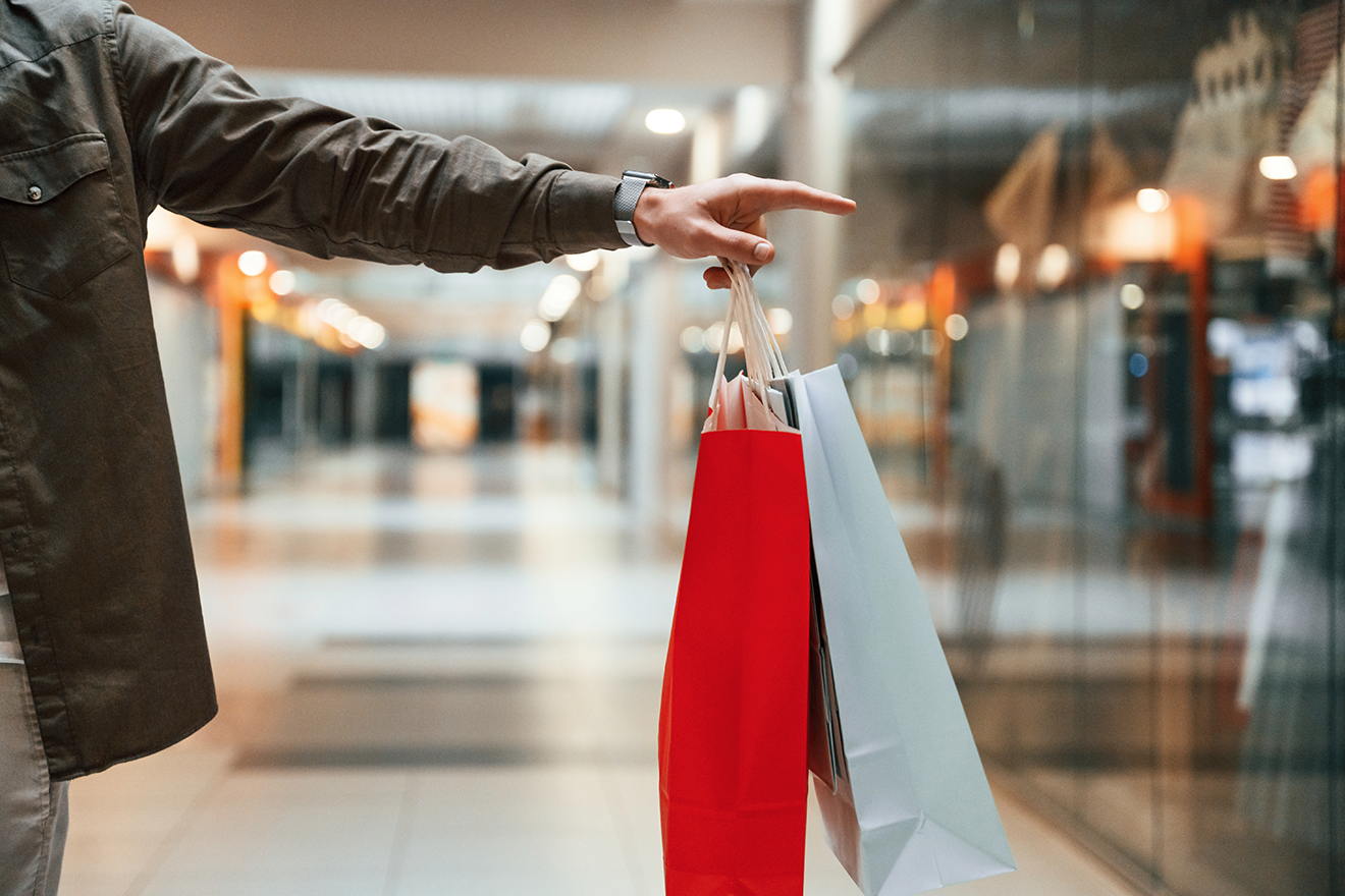 red-and-blue-colored-shopping-bags-in-hands-close-2024-02-21-01-35-31-utc.png